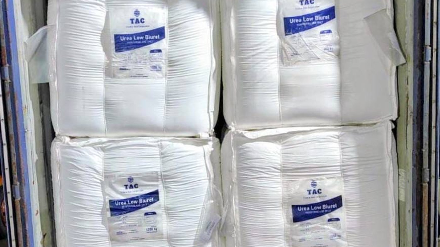 Flexible intermediate bulk containers of industrial grade urea loaded in a shipping container